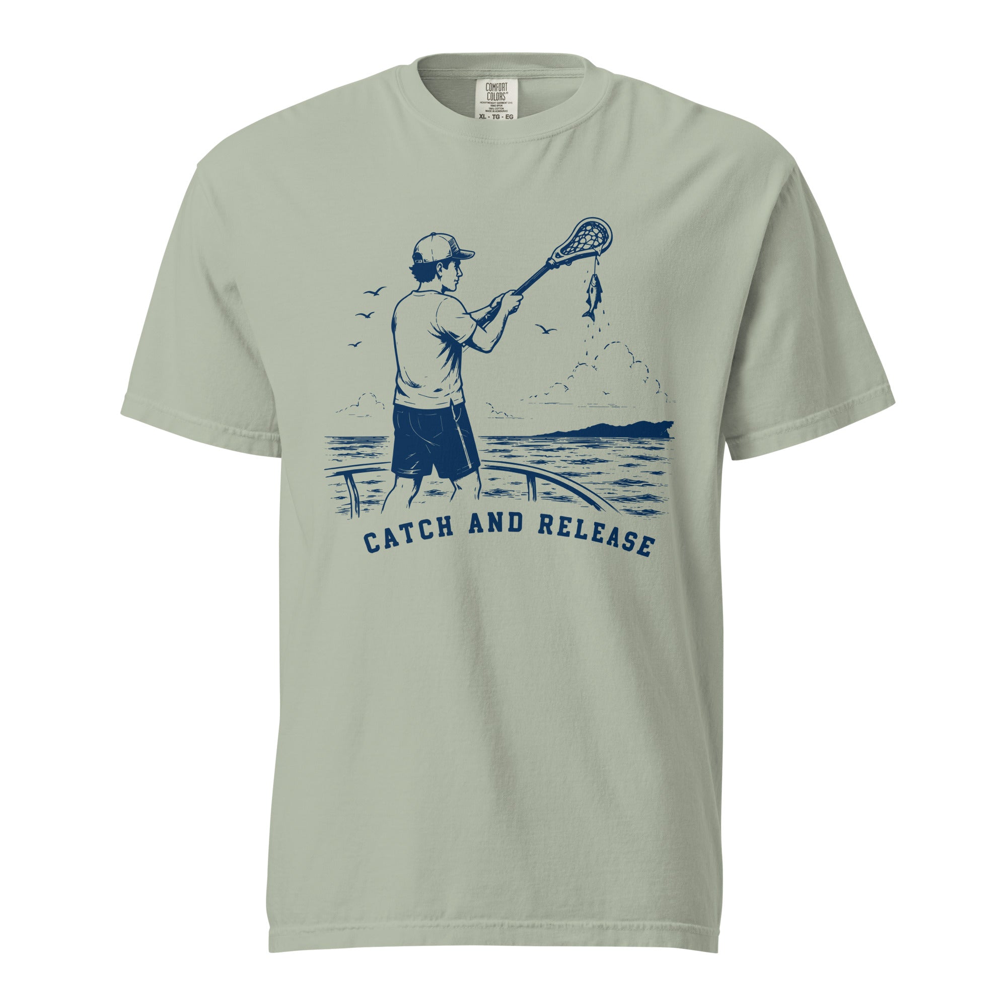 Lacrosse shirt with the GO2X Catch and Release design, a man on a dock holding a lacrosse stick with a fish hanging from the head