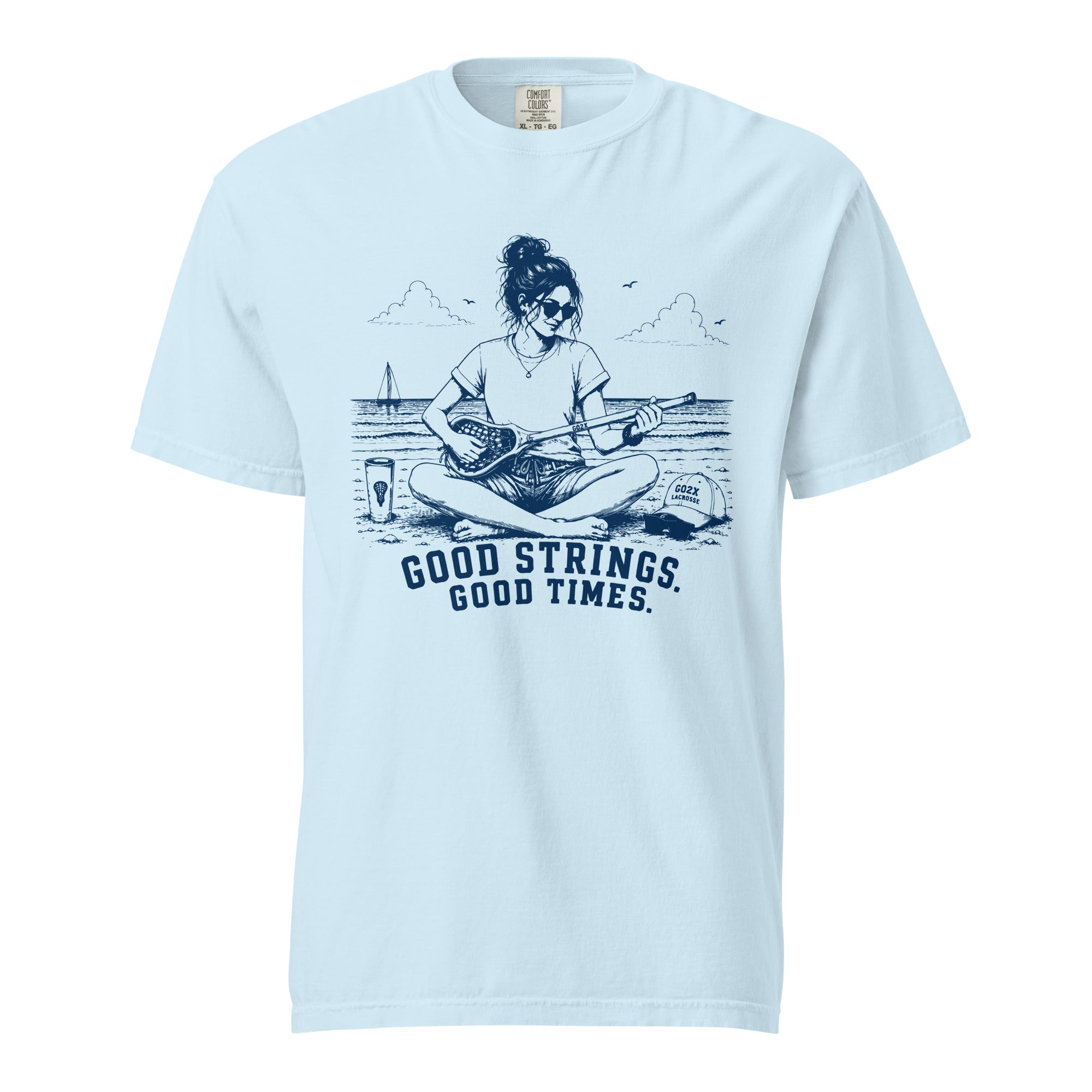 Lacrosse shirt with the GO2X Good Strings Good Times design, a woman on the beach playing a lacrosse stick like a guitar
