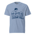 Lacrosse shirt with the GO2X Feeding Goals design, a man feeding a baby in a high chair with a lacrosse stick