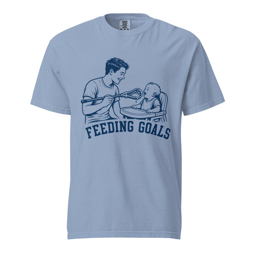 Lacrosse shirt with the GO2X Feeding Goals design, a man feeding a baby in a high chair with a lacrosse stick
