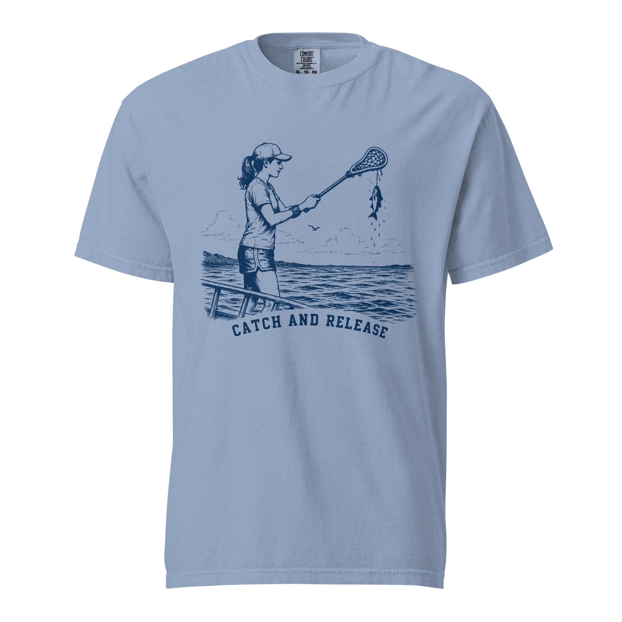 Lacrosse shirt with the GO2X Catch and Release design, a girl on a dock holding a lacrosse stick with a fish hanging from the head
