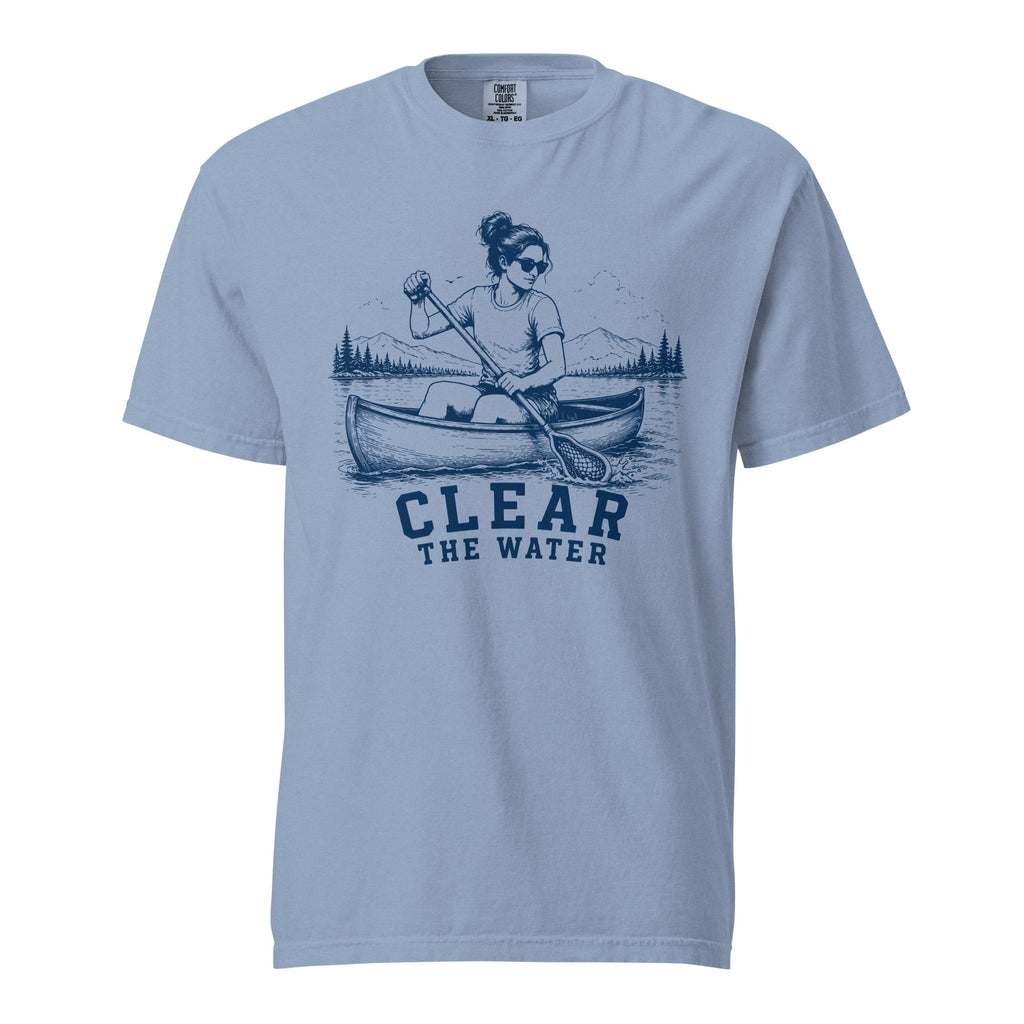 Lacrosse shirt with the GO2X Clear the Water design, a woman paddling a canoe with a lacrosse-head paddle on a mountain lake