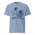 Lacrosse shirt with the GO2X Feeding the Crease design, a woman sliding a pizza into a wood-fired oven with a lacrosse stick