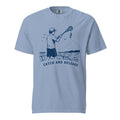 Lacrosse shirt with the GO2X Catch and Release design, a man on a boat holding a lacrosse stick with a fish hanging from the head