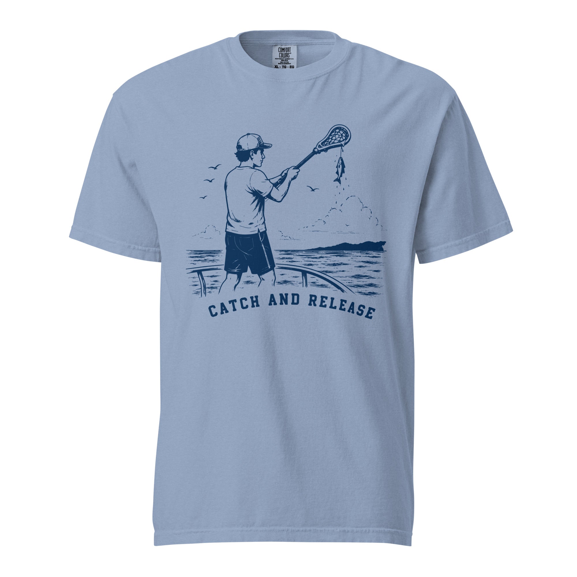 Lacrosse shirt with the GO2X Catch and Release design, a man on a boat holding a lacrosse stick with a fish hanging from the head