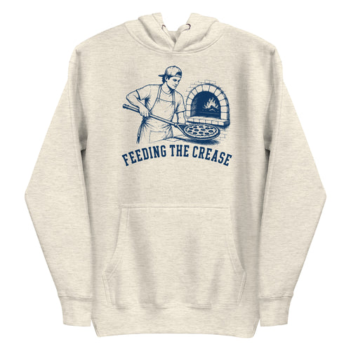 Lacrosse hoodie with the GO2X Feeding the Crease design, a man sliding a pizza into a wood-fired oven with a lacrosse stick