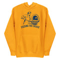 Lacrosse hoodie with the GO2X Feeding the Crease design, a man sliding a pizza into a wood-fired oven with a lacrosse stick